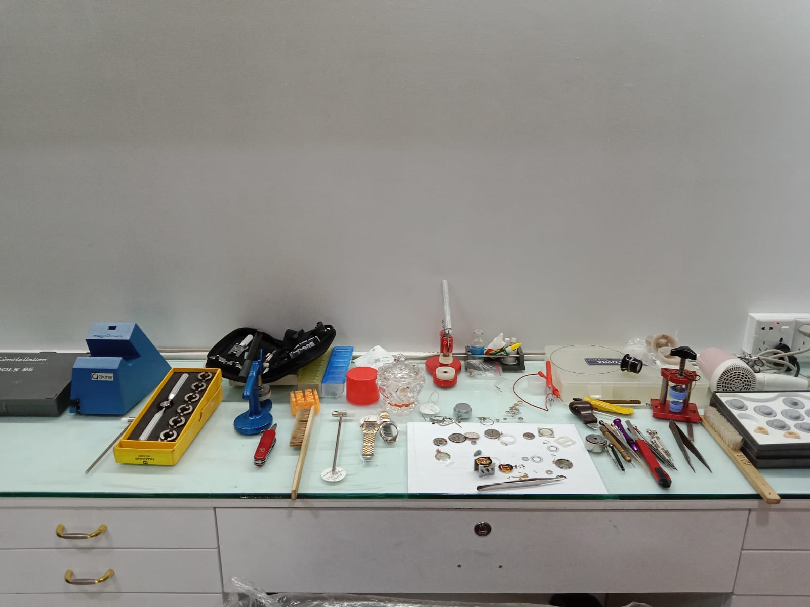 A watch movement being assembled by a watchmaker.